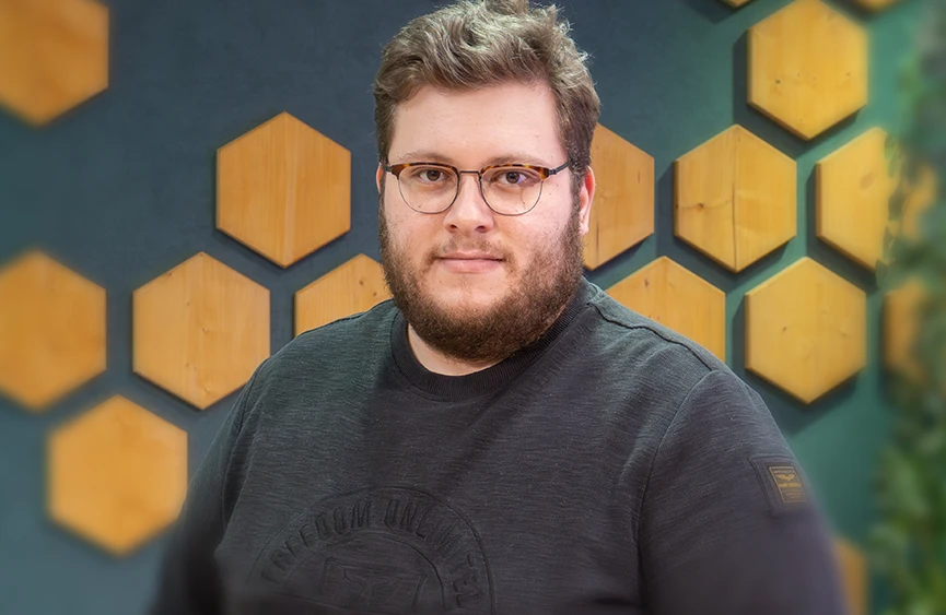 Nico Finkernagel vor einer Wand mit Holzdekoelementen